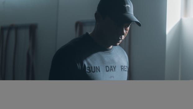 Tiger Woods models a grey Sun Day Red shirt.